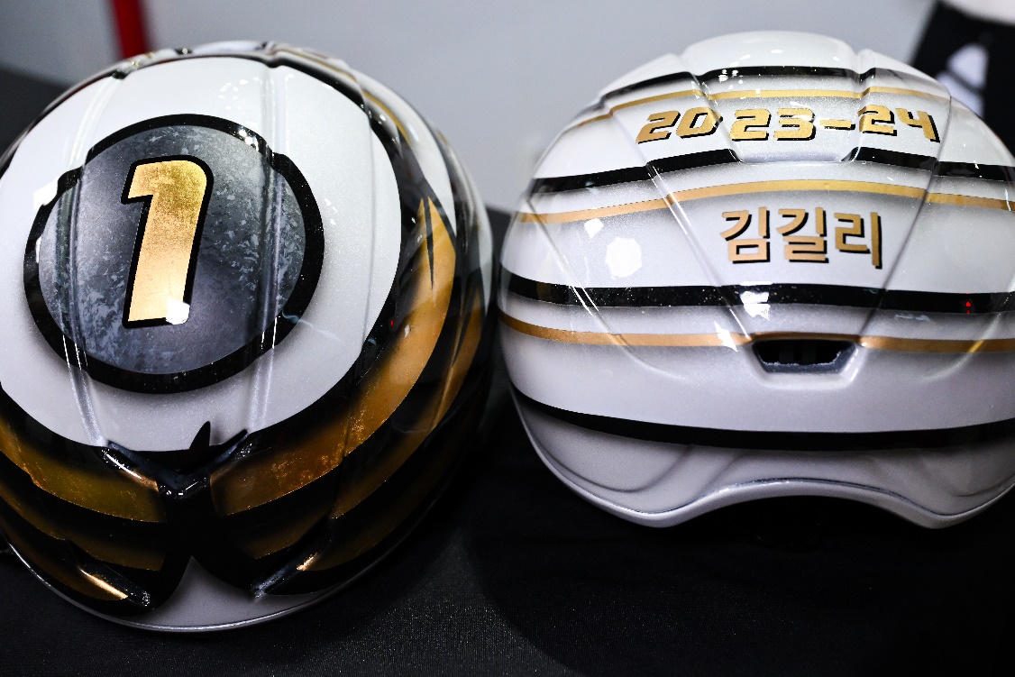 A pair of helmets with gold and black stripesDescription automatically generated